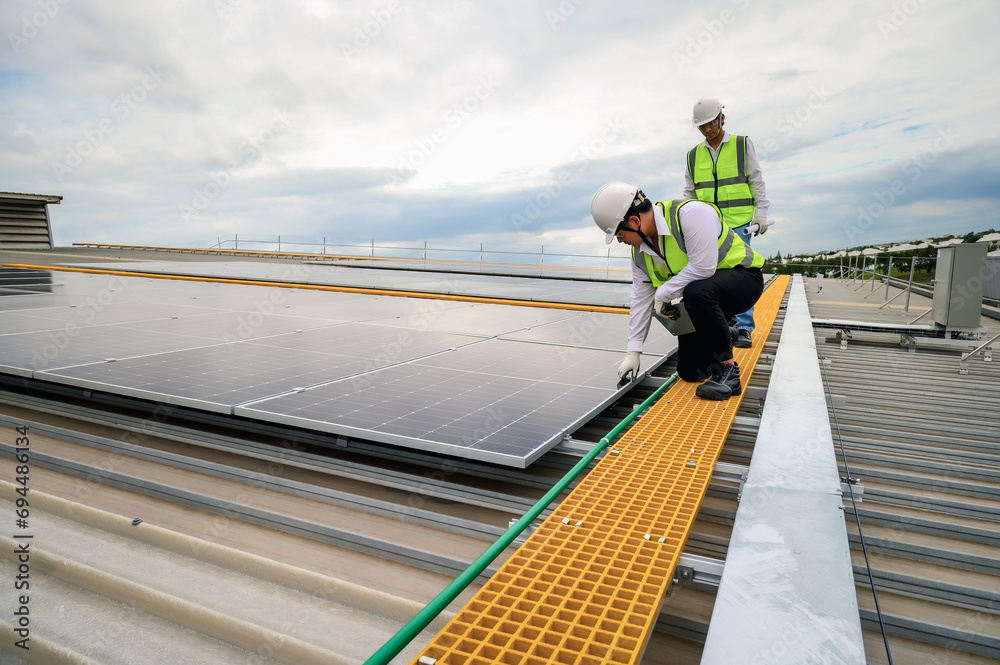 Engineer Team Inspector Quality in Solar Roof Panel Installation, Quality Control in Work of Sustainable Photovoltaic Installation on Factory Roof Buildings. Engineer Team Inspector Quality in Solar Roof Panel Installation, Quality Control in Work of Sustainable Photovoltaic Installation on Factory Roof Buildings.