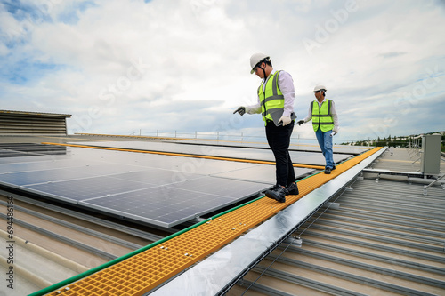 Engineer Team Inspector Quality in Solar Roof Panel Installation, Quality Control in Work of Sustainable Photovoltaic Installation on Factory Roof Buildings.