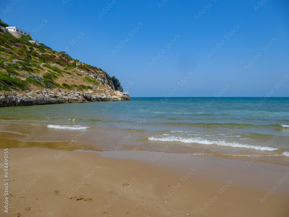 Scenic view of the coastline of Gargano National Park near Sfinale, in Apulia, Italy, Europe. Rocky coastline with large archway carved into cliff face. Natural landmark Mediterranean Adriatic sea.