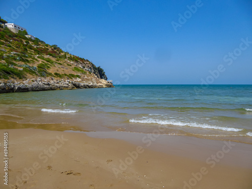 Scenic view of the coastline of Gargano National Park near Sfinale  in Apulia  Italy  Europe. Rocky coastline with large archway carved into cliff face. Natural landmark Mediterranean Adriatic sea.