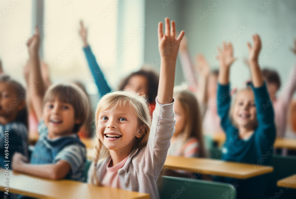 children are raising their hands in a classroom