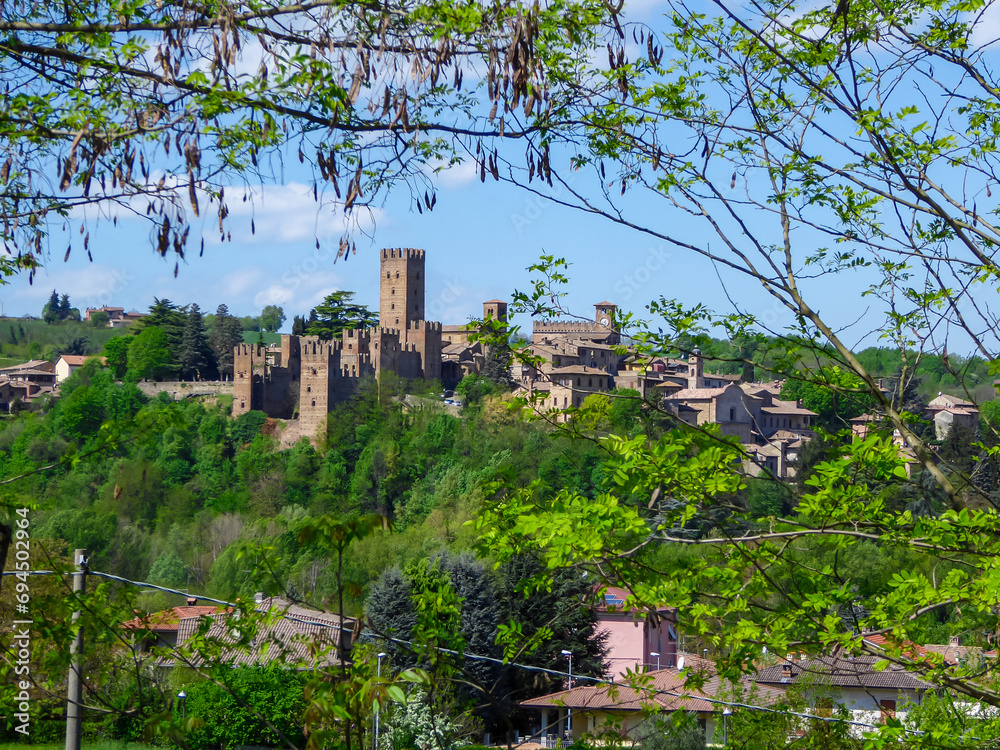 Scenic view of Medieval towns and castles of Emilia Romagna, Italy, Europe. Castel Arquato town and Rocca Viscontea castle on hill surrounded by greenery. Tranquil and calm scenery. Clear blue sky Scenic view of Medieval towns and castles of Emilia Romagna, Italy, Europe. Castel Arquato town and Rocca Viscontea castle on hill surrounded by greenery. Tranquil and calm scenery. Clear blue sky