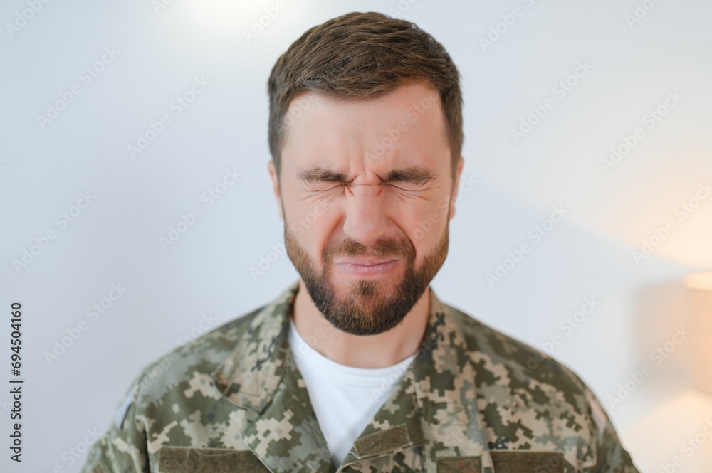 Depressed man recalling war days. Portrait of veteran soldier who has PTSD