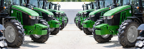 A row of green agricultural tractors photo
