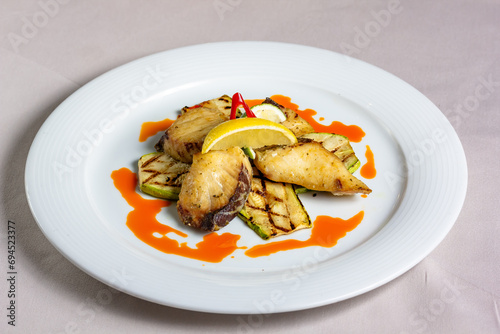 Grilled fish pieces halibut with vegetables © milanchikov