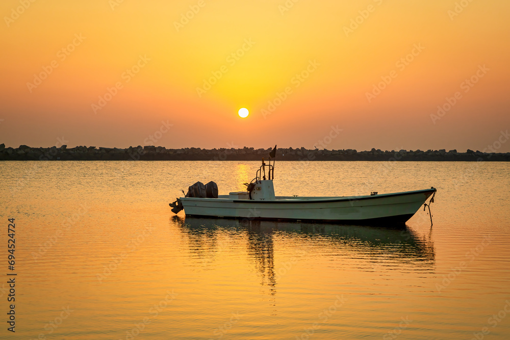 Golden Hour Majesty: Sunrise Silhouettes of Boats on Dammam Corniche, Saudi Arabia