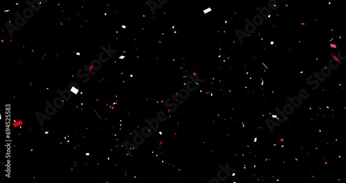 Red and white confetti (sprayed from the center) black background cracker celebration photo