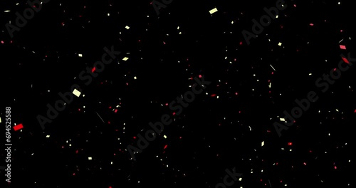 Golden and red confetti (sprayed from the center) black background cracker celebration