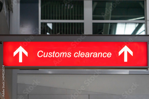 Customs sign in Airport and direction arrow, red and lighted. Travel, tourism, trade concept
