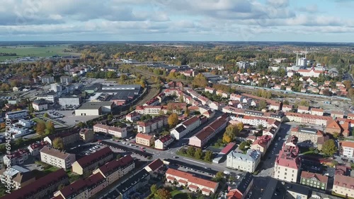 High altitude flight over the center of a small northern European town on a sunny day in Fall