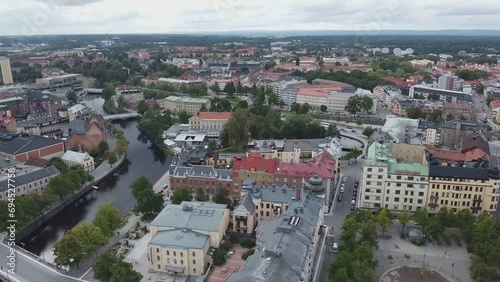 A scenic river flowing through the center of a larger Swedish city on a sunny Summer day