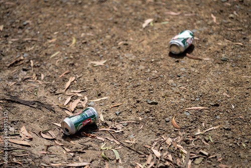 beer can rubbish on the ground photo