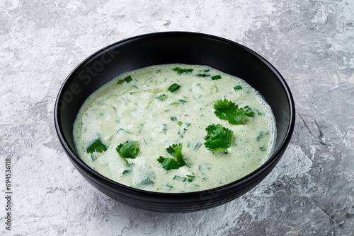 Kefir soup with green onions and cilantro in a bowl. photo