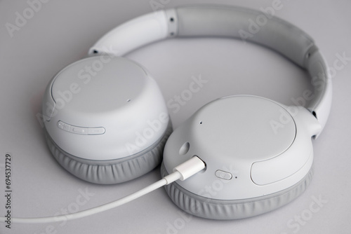 New and modern headphones charging on a table