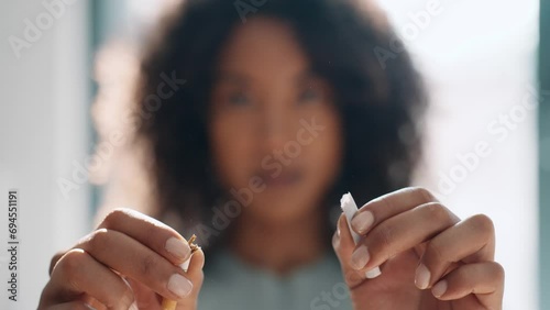 Video of close-up of woman breaking down cigarette to pieces. Quit smoking concept photo