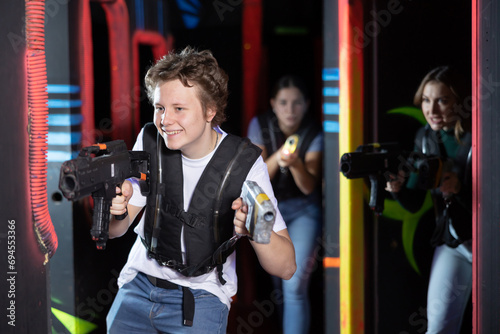 Young guy playing lasertag in arena photo