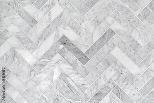 Detailed Texture of White Marble Tiles in Herringbone Design, High-Resolution Background Illustrating Natural Stone Elegance