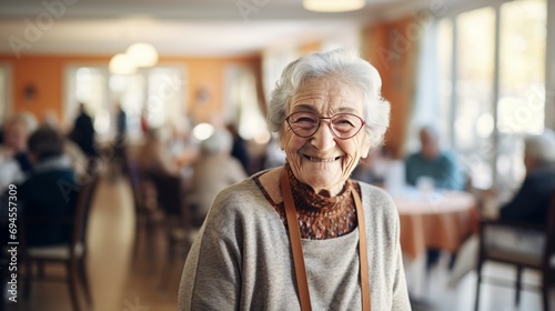 elderly woman smiling while inside a nursing home,  copy space, 16:9 photo
