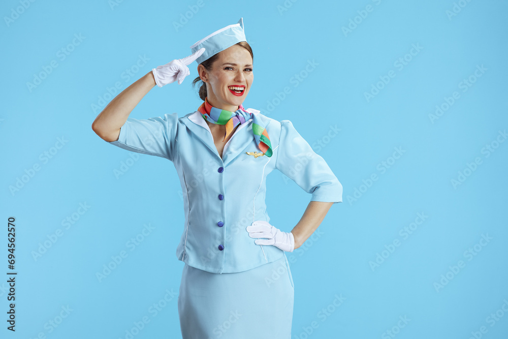smiling elegant female air hostess on blue salutes smiling elegant female air hostess on blue salutes