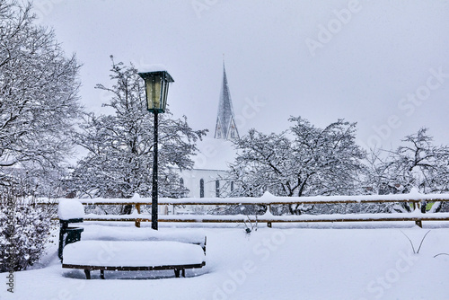 View of snow-covered Bramberg, with the village church in Salzburger Land, Austria, photo