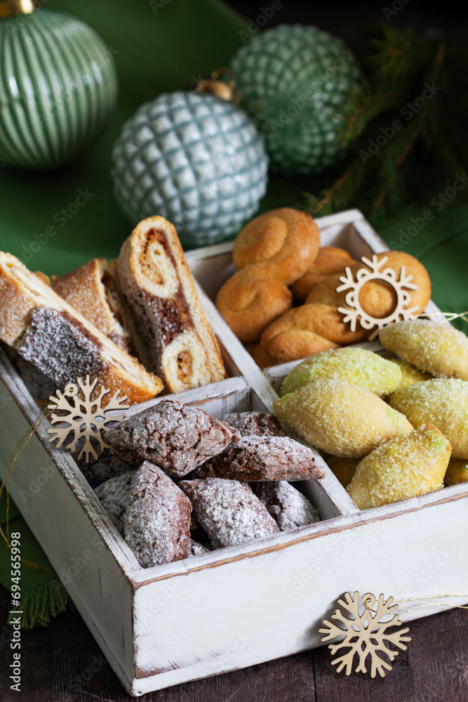 Assorted Christmas cookies with different fillings, Christmas decorations on a wooden background. Rustic style.