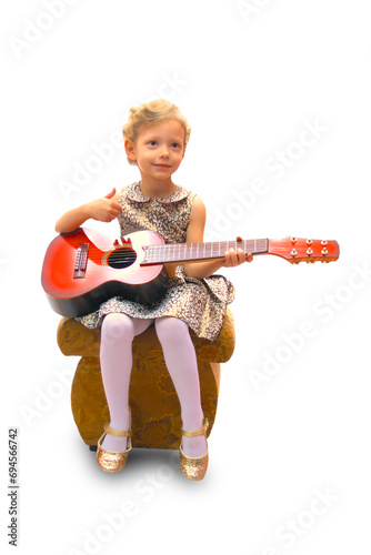 Girl plays the guitar, a smile on her face.