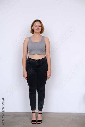 plus size Young girl model snap in grey t-shirt front look full length on white background