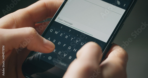 Closeup handheld shot of a woman typing a text message on a smartphone.