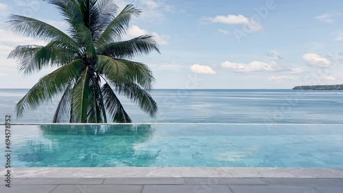 Sea view through the pool and the coke palm tree in clear sunny weather, a coconut palm tree, the coast of Thailand, the shore of the blue sea