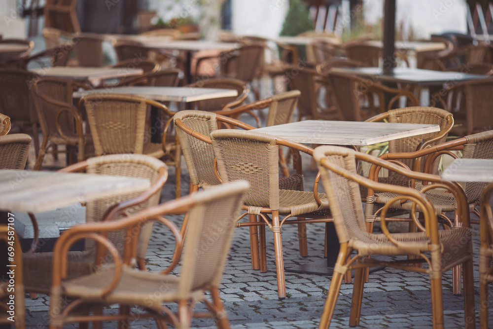 Coffeehouse cafe restaurant terrace. Wooden chairs and tables. Outdoor terrace concept. Shallow focus. Copy space. Old fashioned empty cafe terrace with vintage chairs and tables. Loft style cafe. Coffeehouse cafe restaurant terrace. Wooden chairs and tables. Outdoor terrace concept. Shallow focus. Copy space. Old fashioned empty cafe terrace with vintage chairs and tables. Loft style cafe.