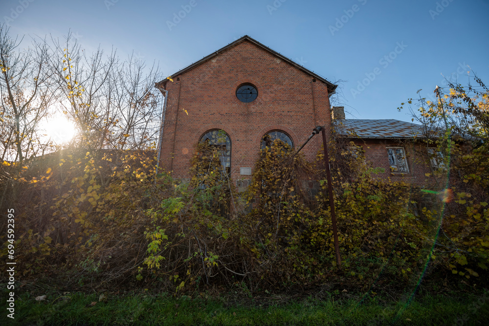 Obraz premium The Enchanting Old Brick Distillery Adjacent to an Abandoned Manor – For Sale