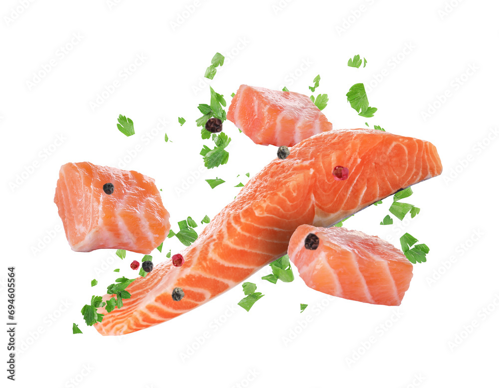 Fresh salmon pieces and spices falling on white background Fresh salmon pieces and spices falling on white background