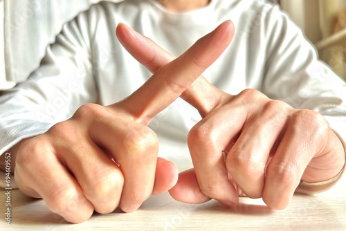 指でバツを作る若い男性・禁止や拒否 photo