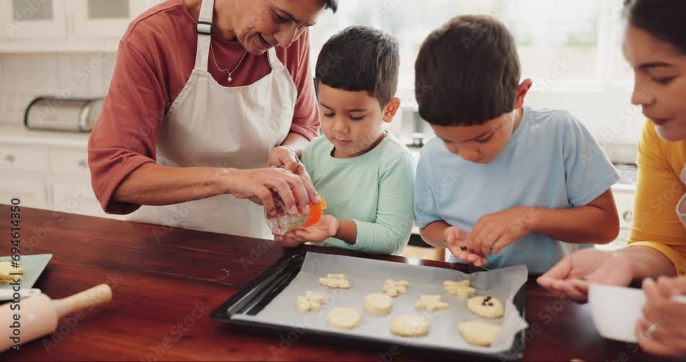 Sprinkles, cookies and children with grandmother and mother in kitchen for sweet treats, dessert or snack. Bonding, child development and boy kids learning to bake biscuits with mom and senior woman.