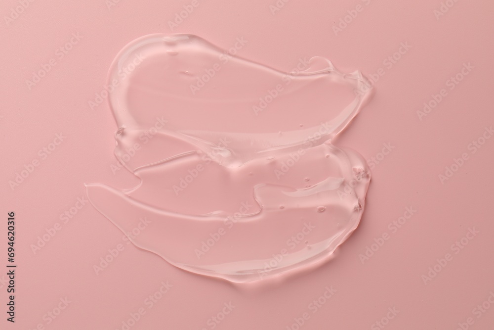 Sample of clear cosmetic gel on pink background, top view Sample of clear cosmetic gel on pink background, top view