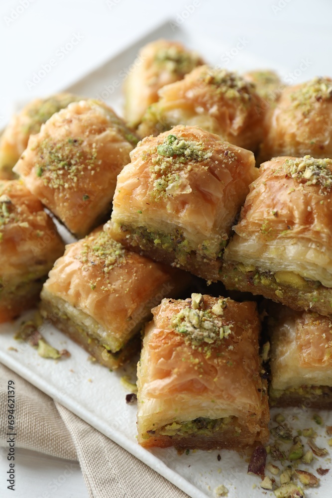 Delicious fresh baklava with chopped nuts on table, closeup. Eastern sweets