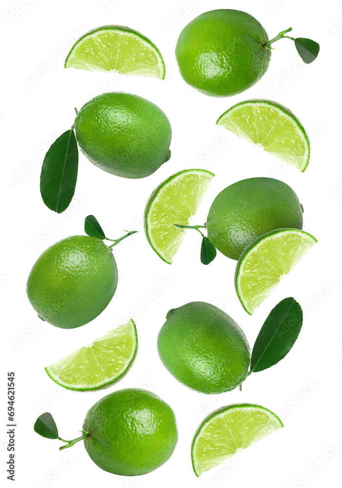 Fresh limes and green leaves falling on white background