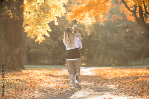 Mothers day, love family. Family on autumn walk in nature outdoors. Mother and child with hugging tenderness