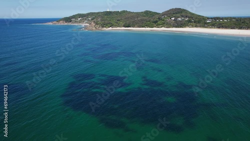 Blue Ocean With Distant View Of The Pass And Fisherman's Lookout On Byron Bay, NSW, Australia. aerial shot photo