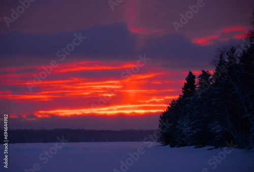Brilliant Orange Red Winter Sunset on Frozen Northern Minnesota Lake