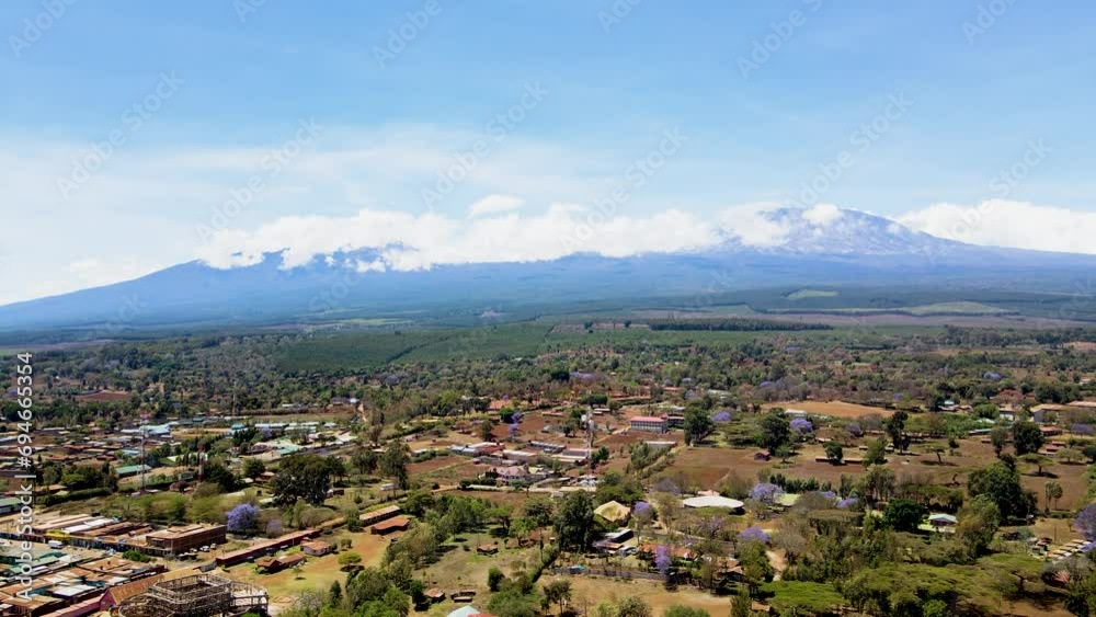 rural village town of kenya with kilimanjaro in the background. Aerial cityscape Mount Kilimanjaro. rural village town of kenya with kilimanjaro in the background. Aerial cityscape Mount Kilimanjaro.