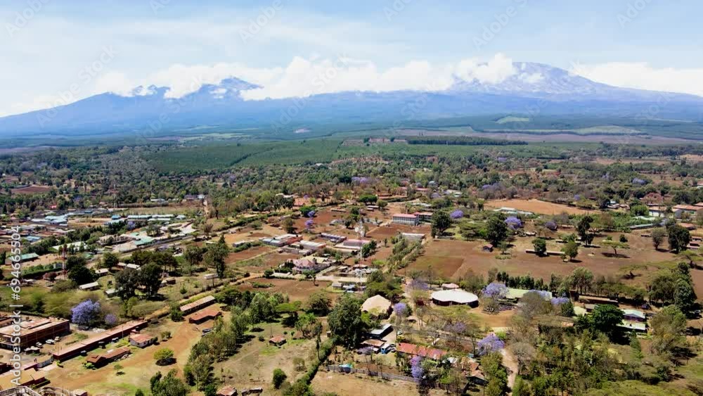 rural village town of kenya with kilimanjaro in the background. Aerial cityscape Mount Kilimanjaro. rural village town of kenya with kilimanjaro in the background. Aerial cityscape Mount Kilimanjaro.