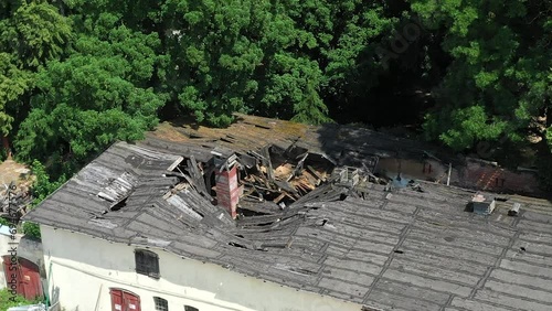 Aerial view of a crumbling roof on a derelict building, as seen from a drone photo