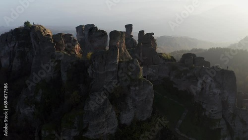 Orbiting drone shot around the famous tourist destination located in Vidin province, the natural rock formations of the historical Belogradchik fortress, in Bulgaria. photo