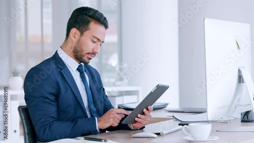 Digital tablet, serious businessman sending an email, searching the internet and browsing online. Entrepreneur using modern technology while writing a business proposal for a startup company photo