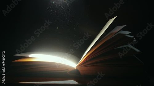 A ray of light falling on an old open book photo