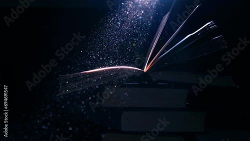 An open book on a stack of books