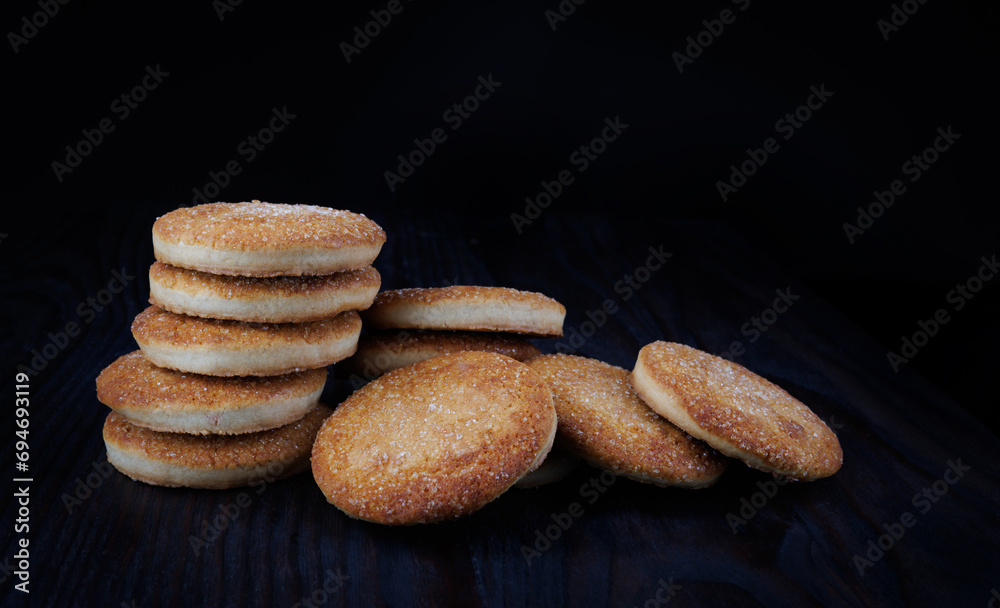 Beautiful round cookies on a black background. A few cookies. A bunch of cookies.