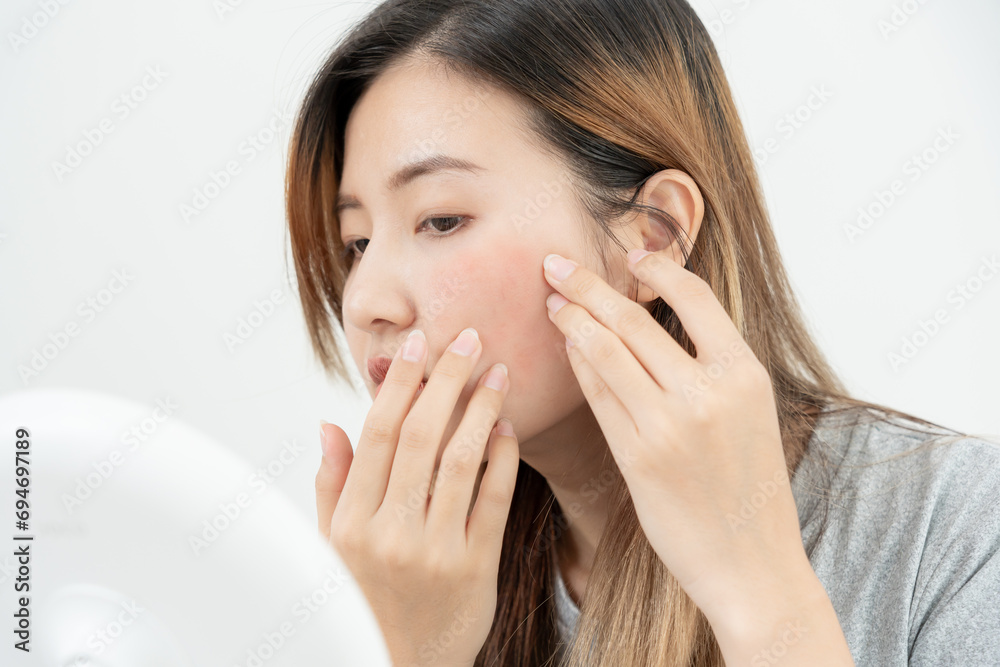 Young woman are worried about faces Dermatology and allergic to steroids in cosmetics. sensitive skin, red face from sunburn, acne, allergic to chemicals, rash on face. skin problems and beauty Young woman are worried about faces Dermatology and allergic to steroids in cosmetics. sensitive skin, red face from sunburn, acne, allergic to chemicals, rash on face. skin problems and beauty