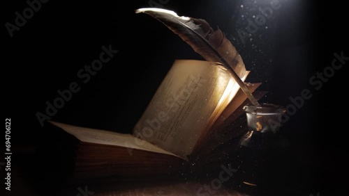 Book, pen and inkwell in a ray of light